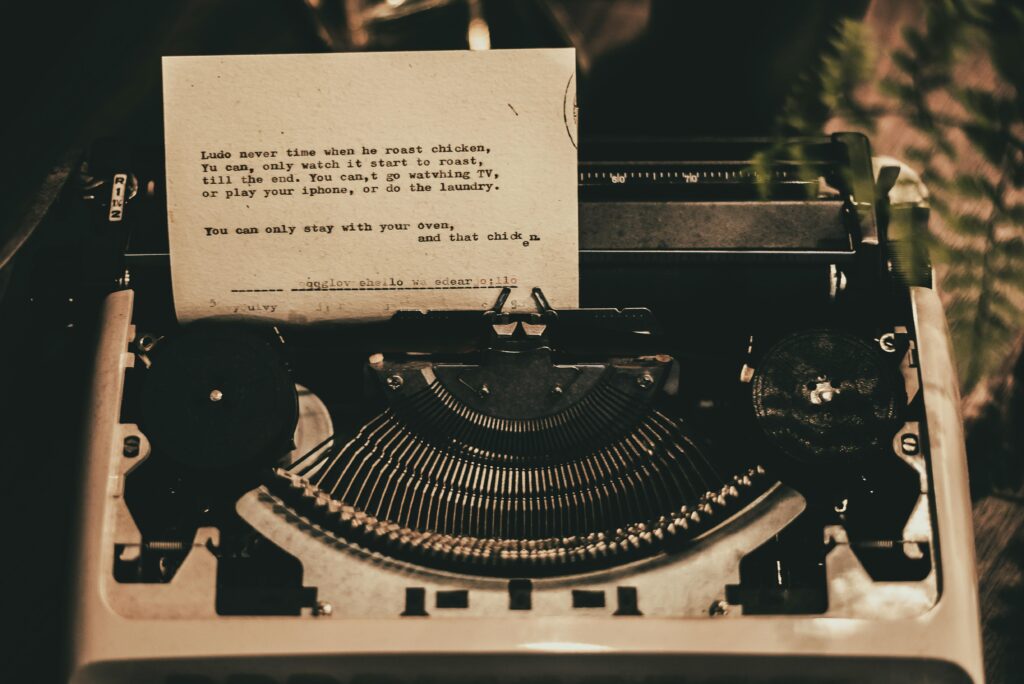 An antique typewriter displaying a typed poem in a nostalgic sepia tone.